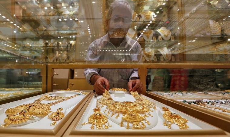 A salesman arranges a gold necklace in a display case inside a jewellery showroom on the occasion of Akshaya Tritiya, a major gold buying festival, in Kolkata, India, May 9, 2016. REUTERS/Rupak De Chowdhuri A salesman arranges a gold necklace in a display case inside a jewellery showroom on the occasion of Akshaya Tritiya, a major gold buying festival, in Kolkata, India, May 9, 2016. REUTERS/Rupak De Chowdhuri
