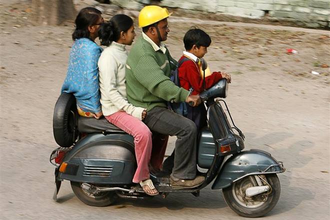 A family rides on a scooter in the northeastern Indian city of Siliguri January 11, 2008. Two wheeler prices are likely to slide and banks' car loan portfolios are set to rise from October when millions of consumers start buying the world's cheapest car made by Tata Motors, a survey said on Friday. REUTERS/Rupak De Chowdhuri (INDIA)