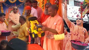sunglasses toy bulldozer Yogi Adityanath celebrates Holi in Gorakhpur