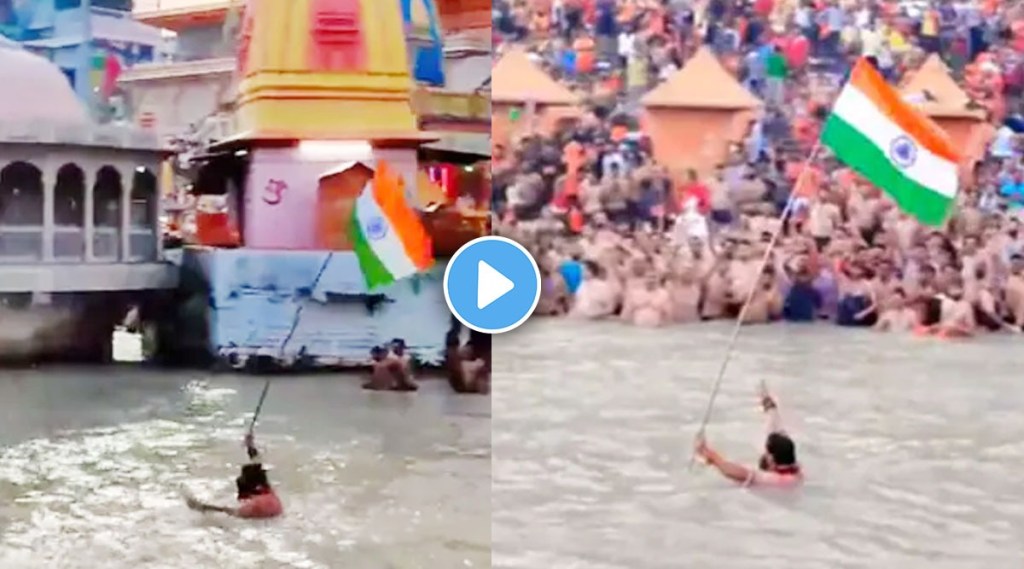 Man hoists tricolor in river Ganga at Har Ki Pauri ghat in Haridwar Man hoists tricolor in river Ganga at Har Ki Pauri ghat in Haridwar