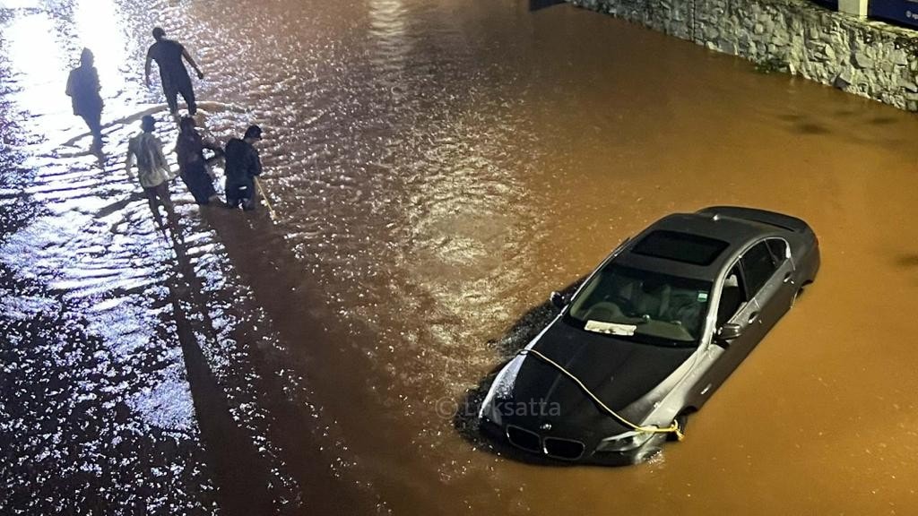 Pune Rain Photos A BMW 5 series car held on a submerged road near Vibgyor school at NIBM annex