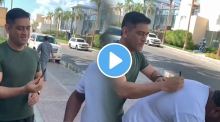 A video of MS Dhoni signing an autograph on the back of a fan on the roadside is going viral