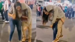 Girl carries boy on her back