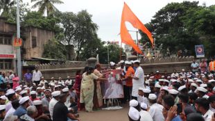 Milk anointing on Sambhaji Bhide image