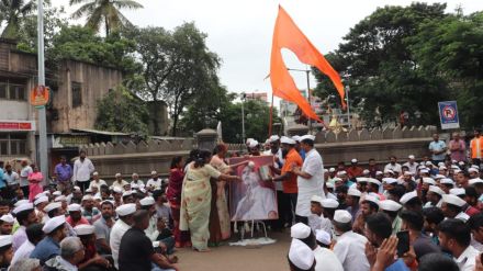 Milk anointing on Sambhaji Bhide image