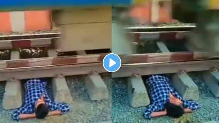Man make reel lying under rain track high speed train passing indian railway video viral on social media Man make reel lying under rain track high speed train passing indian railway video viral on social media