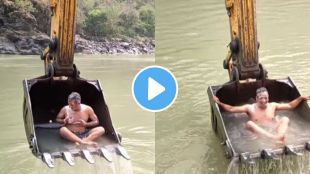 a young man taking bath in river with the help of jcb watch funny video
