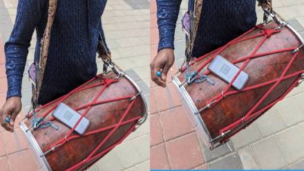 Drummer puts cure code scanner on drum to collect money