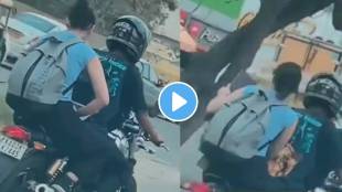 A girl started a laptop on a moving bike on Bangalore road