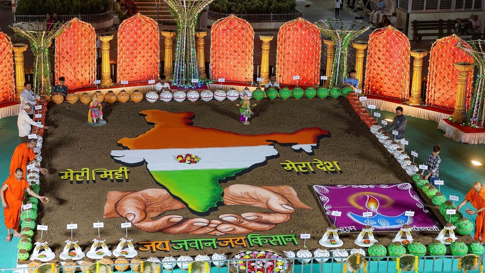 Ahmedabad: Hindu priests give finishing touches to a rangoli at a temple for the Diwali celebrations (PTI Photo)