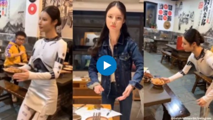 Is this waitress serving at a restaurant in China robot or human Is this waitress serving at a restaurant in China robot or human