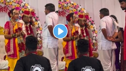 a groom talking on a mobile phone in front of gurujee and bride on wedding day