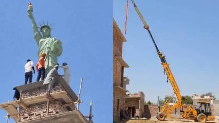 viral video locals placing a replica of the Statue of Liberty on the roof of an under construction building watch ones