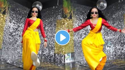 A young woman wearing a sari dances to the song Pushpa Pushpa