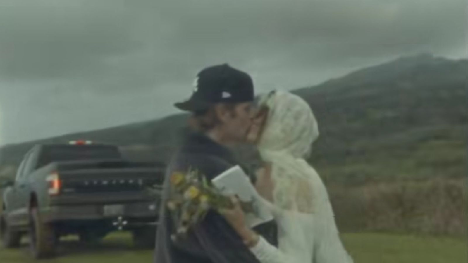Hailey is wearing a white laced gown, resembling her previous wedding dress.