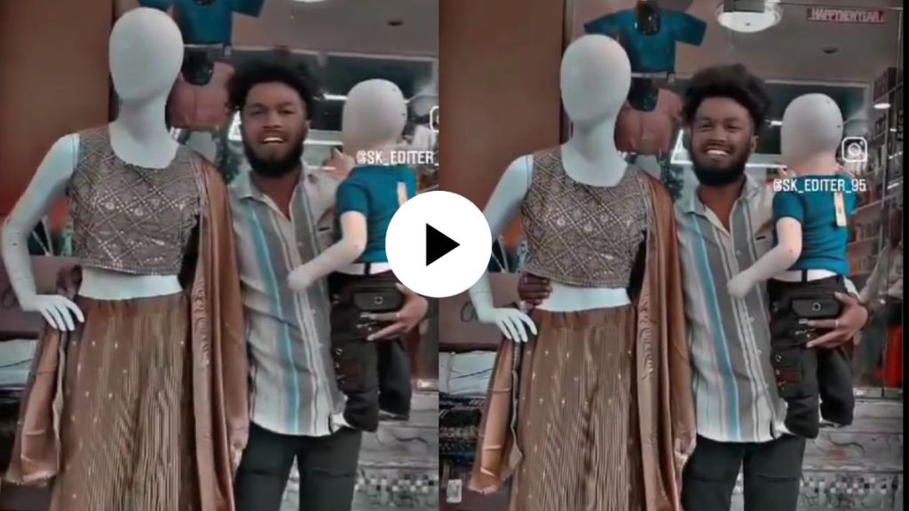 a young boy click family photo with statues at cloth shop