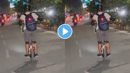 Man Riding Unicycle and balancing a cycle bearing just one wheel on the roads of India people caught the incident on camera