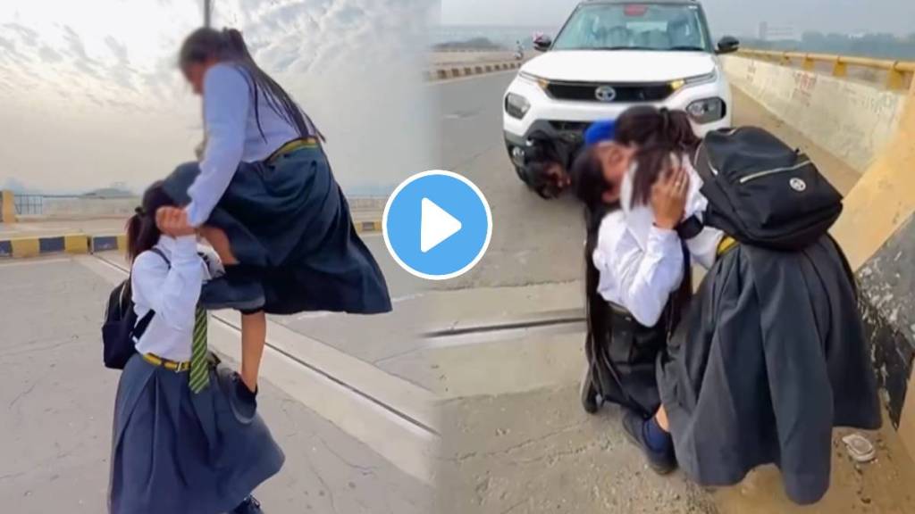 two school girls performing stunts together on the road One stands Second Student shoulders and does a backflip in the air watch ones