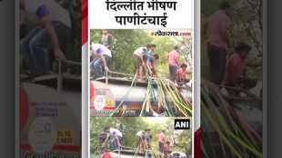 Water Crisis in Delhi People climb atop water tankers to collect water