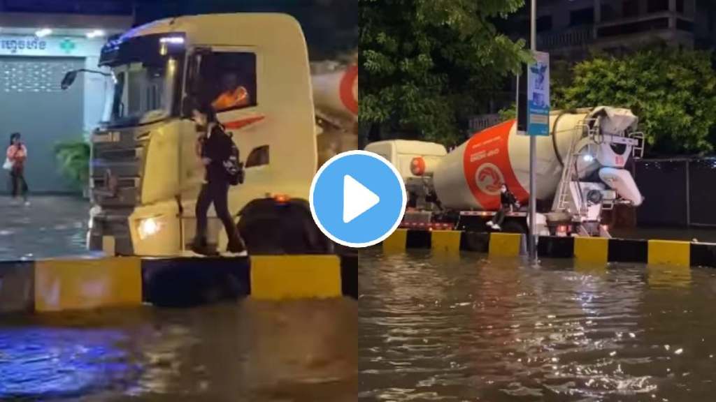 truck driver helps young girl cross waterlogged street during heavy rainfall truck driver helps young girl cross waterlogged street during heavy rainfall