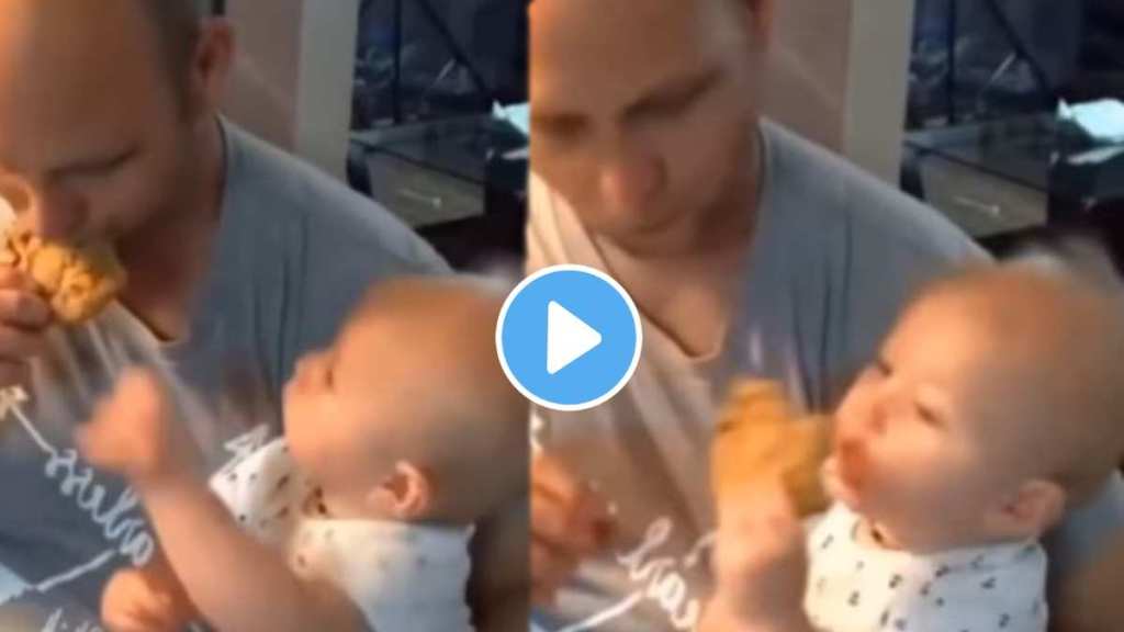 This baby quickly pulled the food from father's hand and eat This baby quickly pulled the food from father's hand and eat