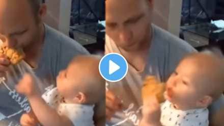 This baby quickly pulled the food from father's hand and eat This baby quickly pulled the food from father's hand and eat