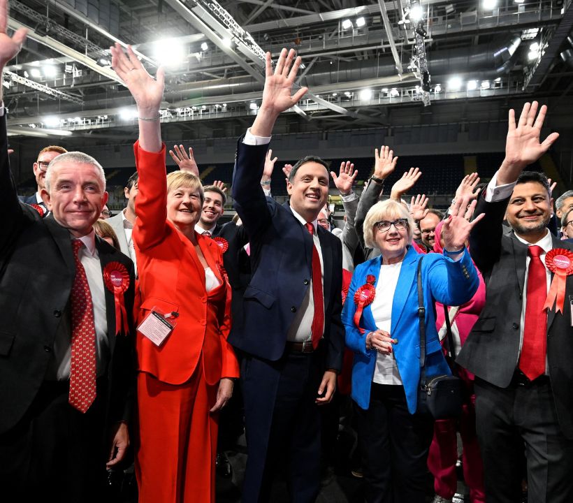 Scottish Labour leader Anas Sarwar waves along with members of the Labour party, as the counting of votes continues, during the UK election in Glasgow, Scotland.