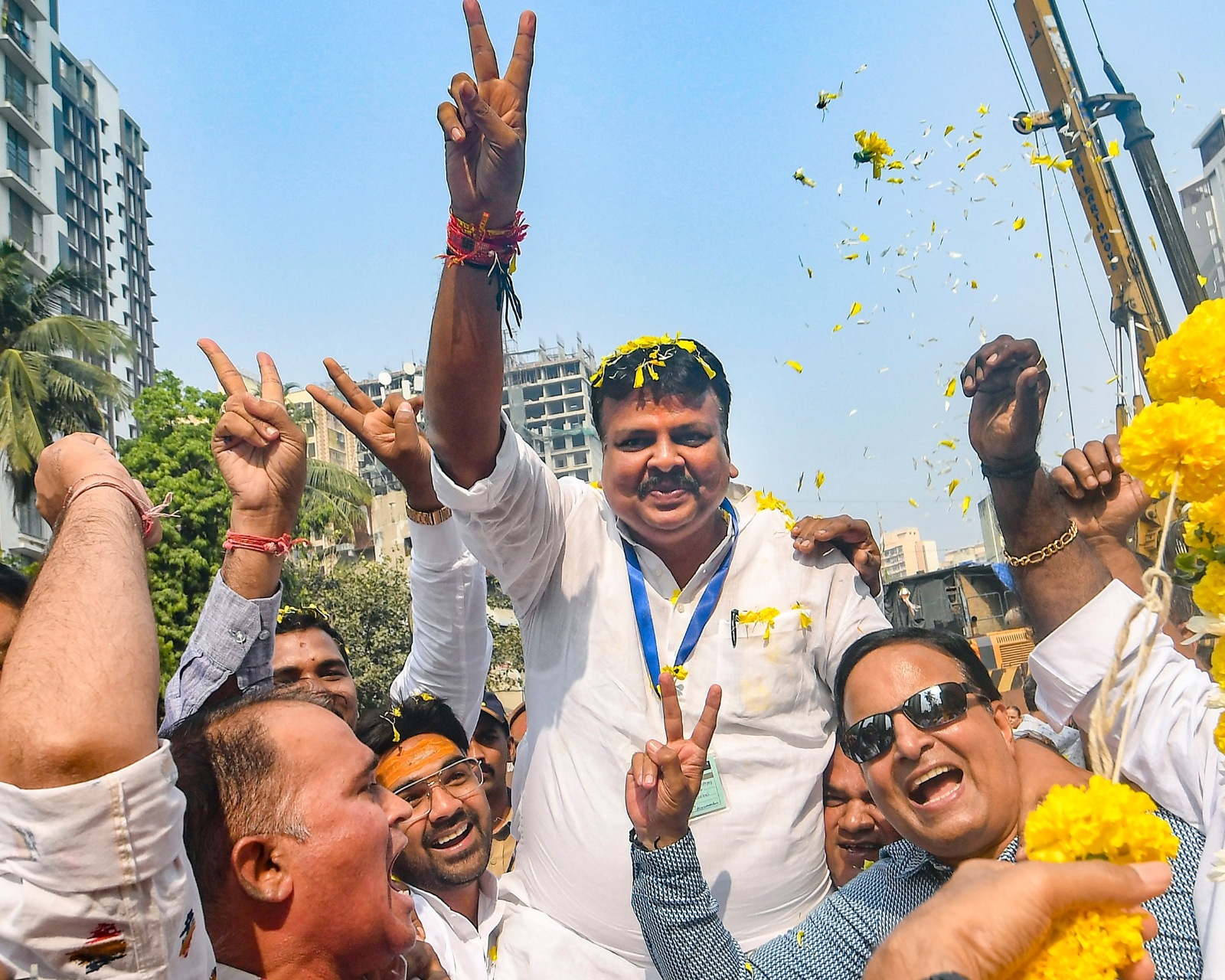 BJP candidate Sanjay Upadhyay celebrates with his followers following the Maharashtra Assembly election vote count after securing a commanding lead. (Photo credit: PTI)