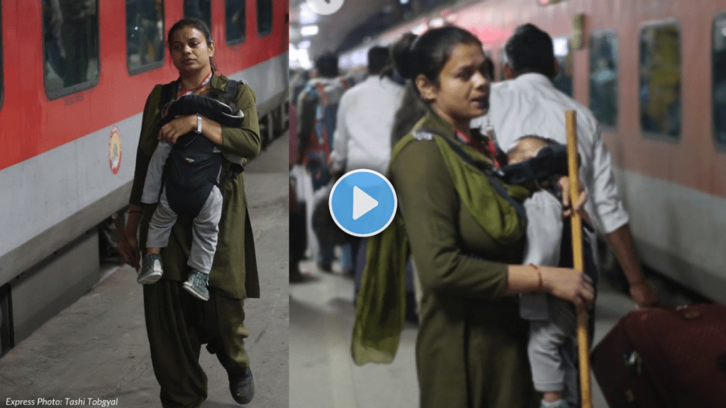 RPF woman constable patrols crowded New Delhi Railway Station platforms with baby in carrier RPF woman constable patrols crowded New Delhi Railway Station platforms with baby in carrier