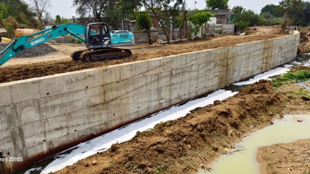 BJP MLA built wall in drain for his own plot using government funds BJP MLA built wall in drain for his own plot using government funds