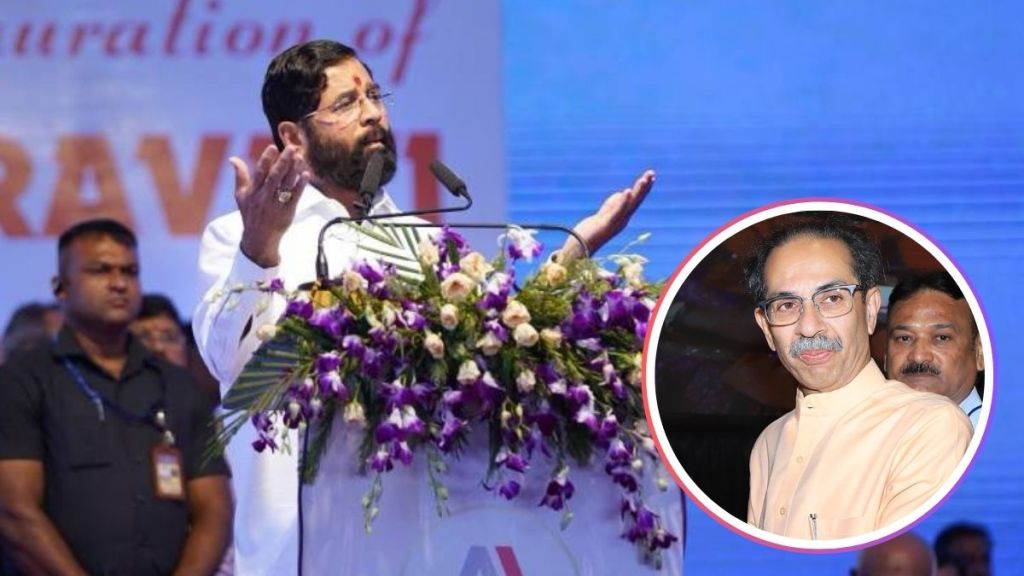 Eknath Shinde addressing media with a video of Balasaheb Thackeray in the background.