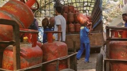 Delivery workers handling 19-kg LPG cylinders in New Delhi after the recent price cut.