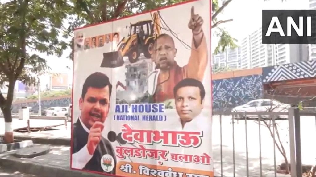 Poster outside AJL House in Mumbai with images of Devendra Fadnavis and Yogi Adityanath
