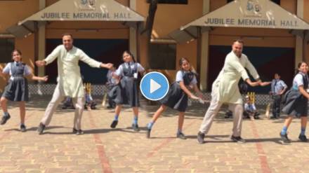 students dance with teacher