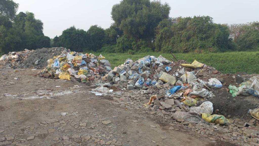 debris thrown away in the creek construction of illegal chawls Kopar village Dombivli