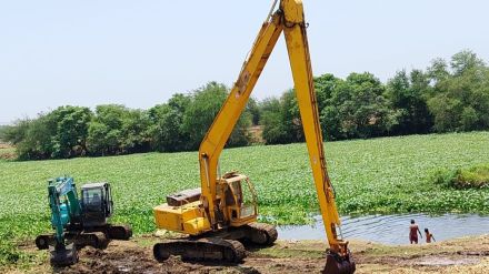 removing Leaf vine from godavari river due to limitations of machine work can only be done near edge