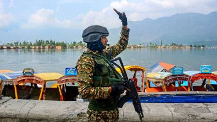 A security personnel stands guard in Jammu and Kashmir, along the Dal Lake