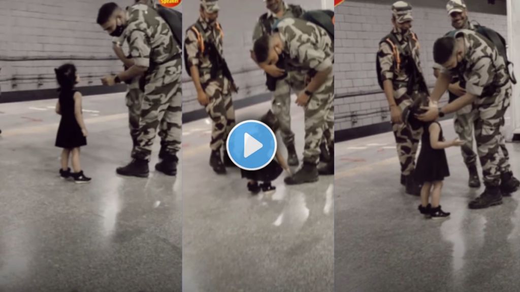 Little girl touching the feet of Indian soldiers showing respect