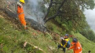 Rescue and relief personnel at the site of the helicopter crash near Gaurikund. (Express Photo)