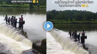 Children crossing a flooded bandhara