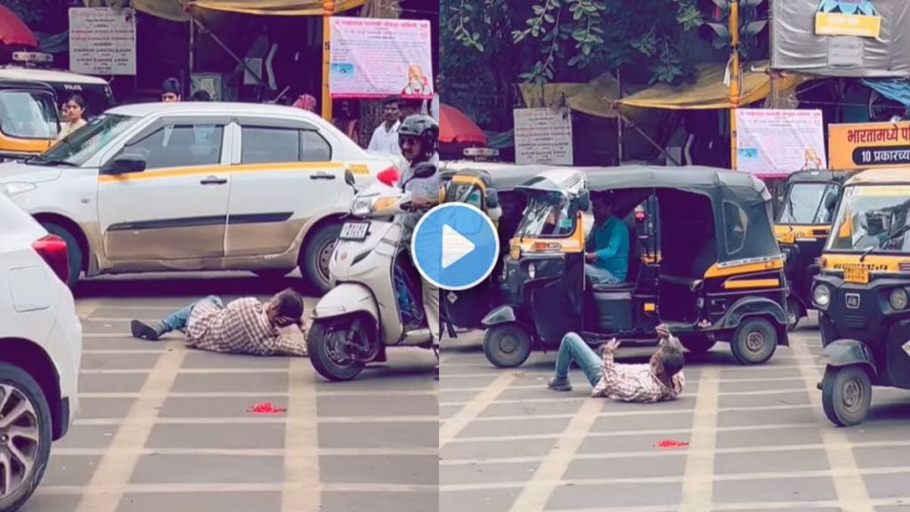 Man lying down asleep in the middle of a city road