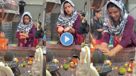a woman making reel in front of shivling in temple