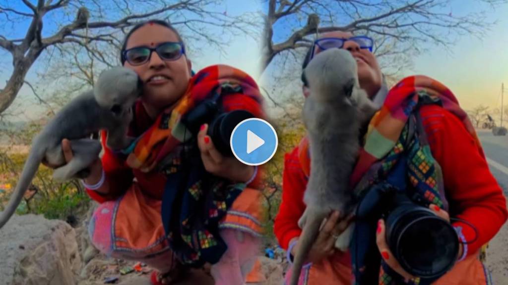 A baby monkey kissed a woman