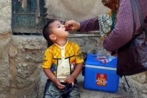 A boy receives polio vaccine drops, during an anti-polio campaign, in a low-income neighbourhood in Karachi (Reuters)