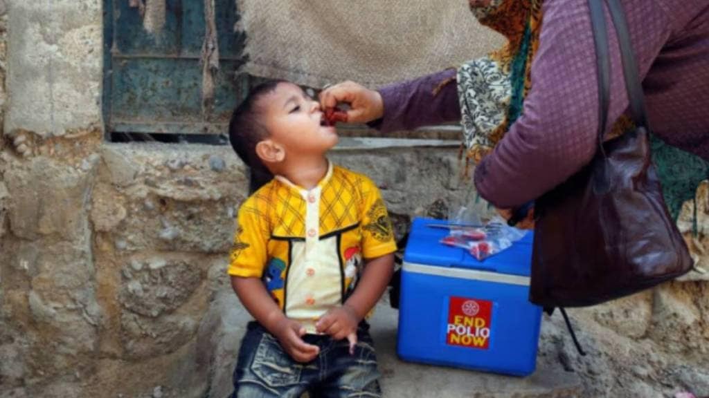 A boy receives polio vaccine drops, during an anti-polio campaign, in a low-income neighbourhood in Karachi (Reuters)