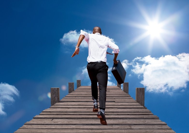 Digital composition of businessman running with briefcase on boardwalk against sky in background