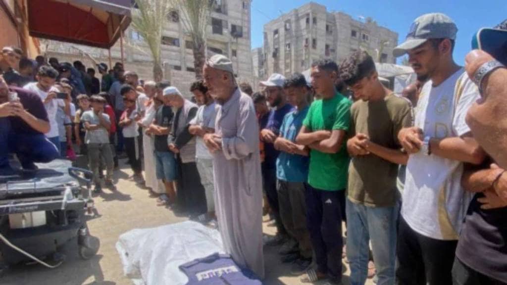 In this family handout photo, Riyad Dagga, center, and other relatives and friends pray over the body of his daughter, freelance journalist Mariam Dagga, 33, during her funeral after she was killed in a double Israeli strike on Nasser Hospital in Khan Younis, southern Gaza Strip (AP/PTI)