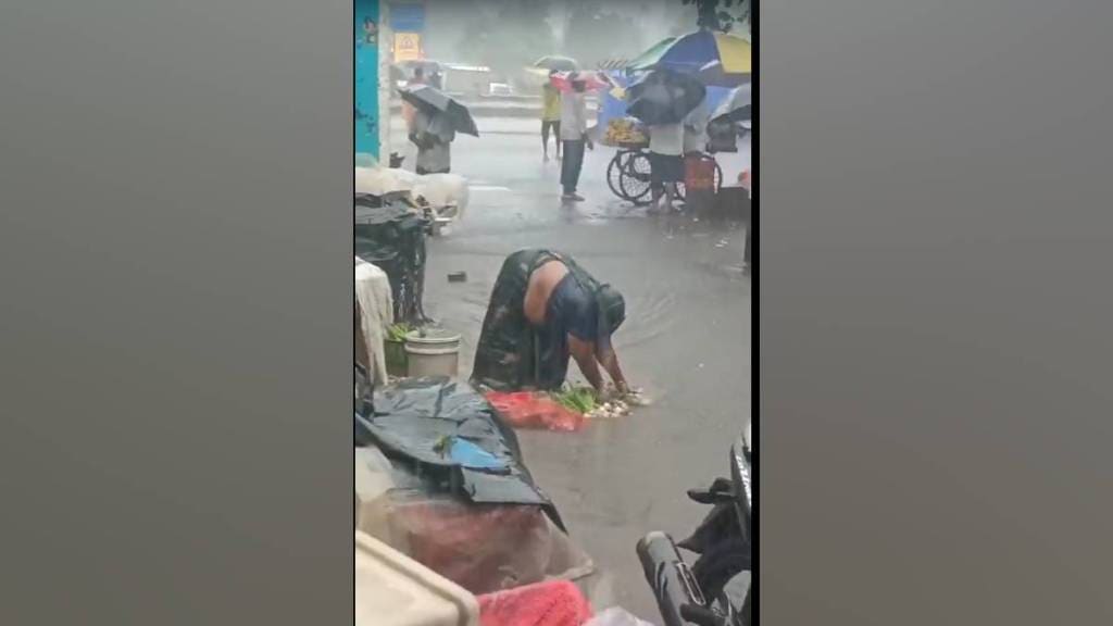 video of a female vegetable vendor washing vegetables in sewer water
