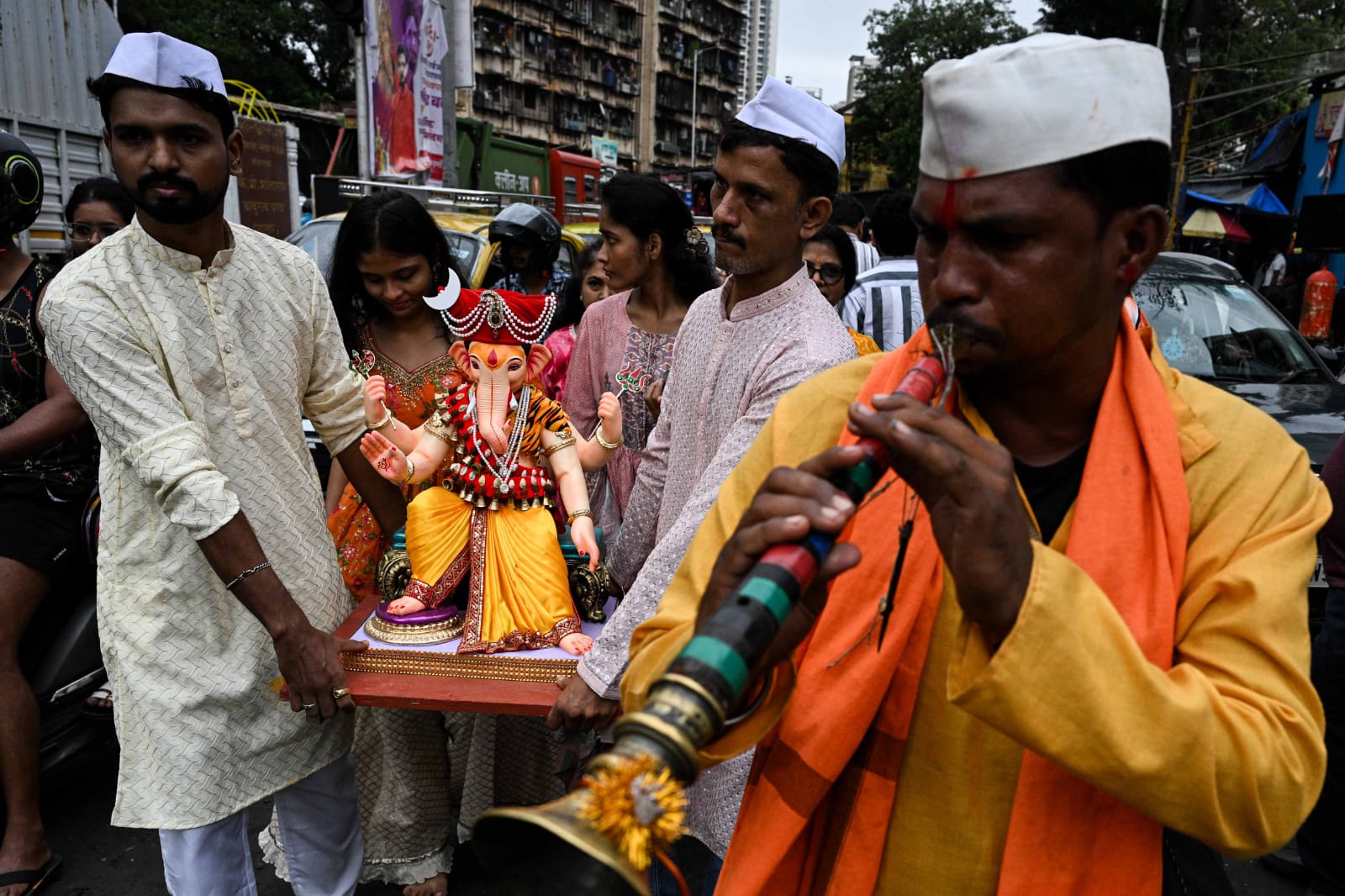 People carry Ganesh idols to their respective homes on the occasion of Ganesh Chaturthi festival, at Lalbaug