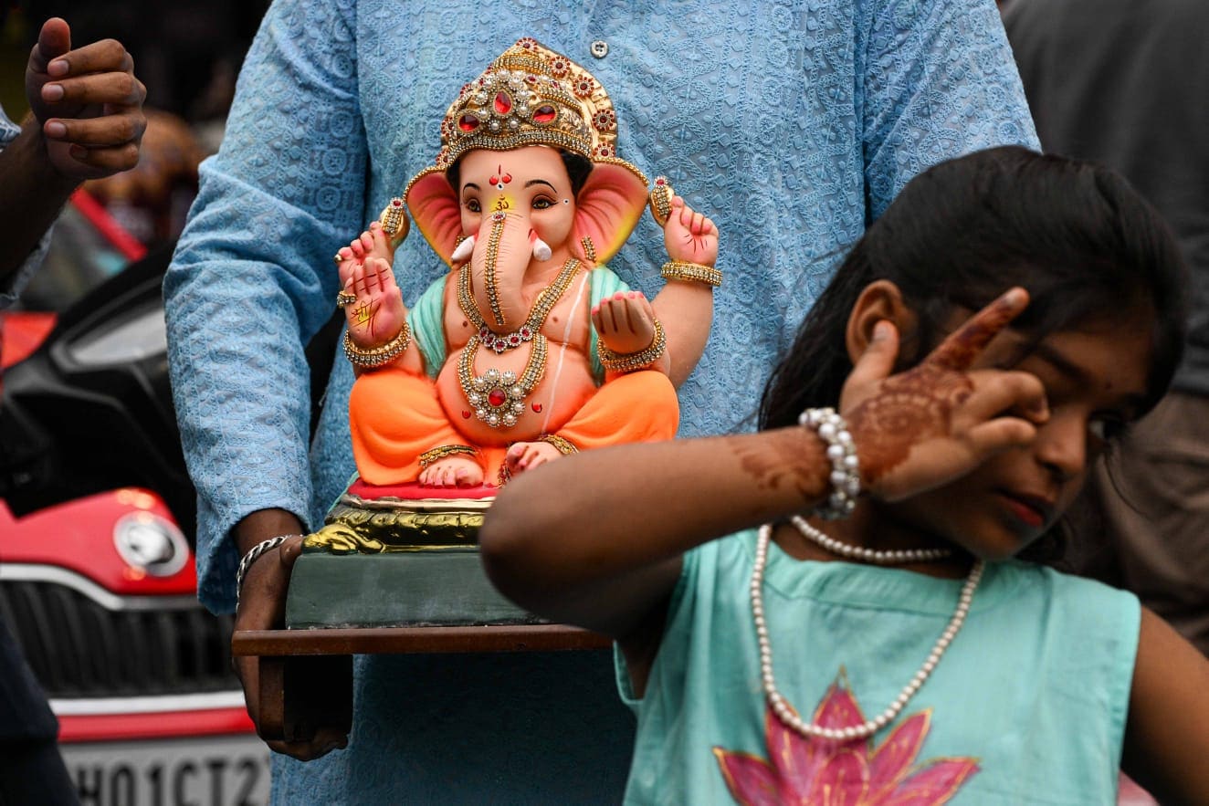 People carry Ganesh idols to their respective homes on the occasion of Ganesh Chaturthi festival, at Lalbaug